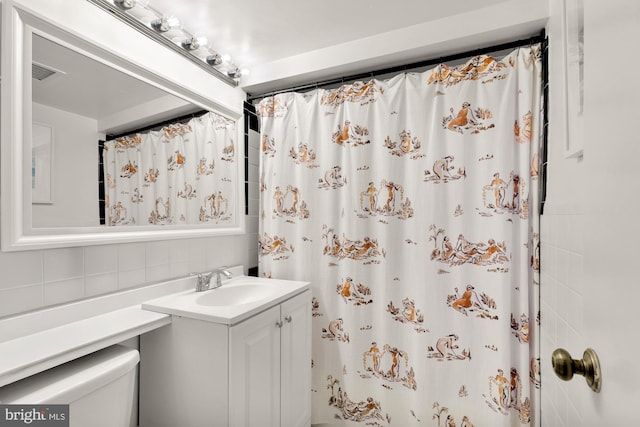 3825 Davis Pl NW Unit 202, Washington, DC 20007 - full bathroom with decorative backsplash, vanity, toilet, and curtained shower