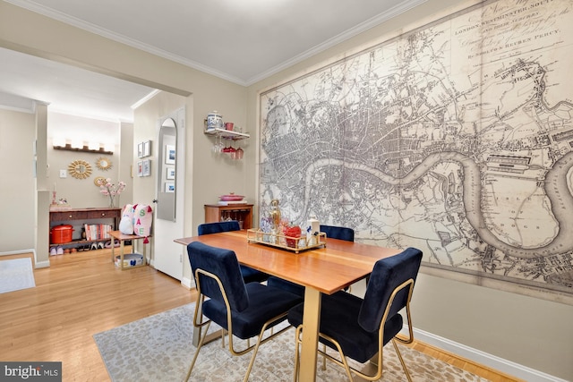 3825 Davis Pl NW Unit 202, Washington, DC 20007 - dining room featuring wood finished floors, crown molding, baseboards, and arched walkways