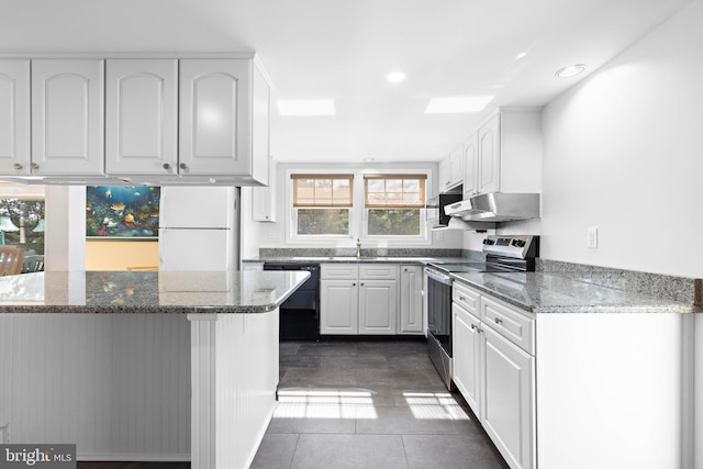 kitchen featuring freestanding refrigerator, stainless steel range with electric stovetop, white cabinets, a sink, and dishwasher