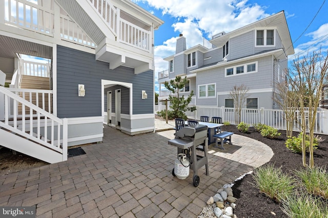 view of patio with outdoor dining area and fence