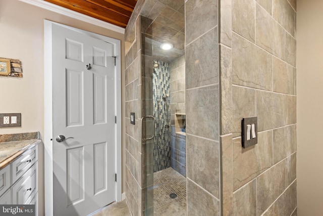 full bath with crown molding, vanity, and a stall shower