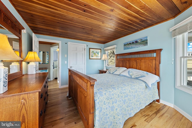bedroom with baseboards, wooden ceiling, and multiple windows