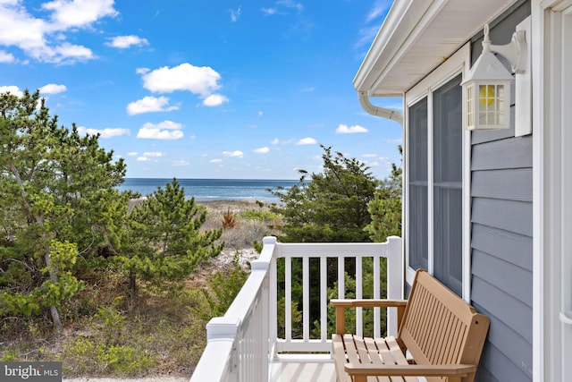 balcony with a water view and a beach view