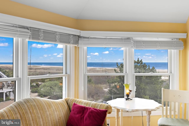 sunroom / solarium featuring a water view and a healthy amount of sunlight