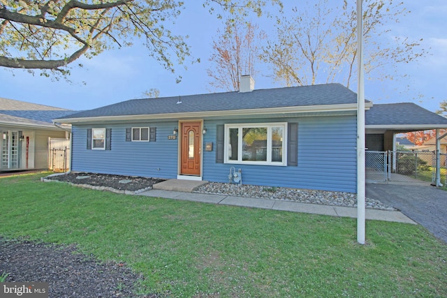 ranch-style home featuring fence, aphalt driveway, a front yard, a chimney, and a carport