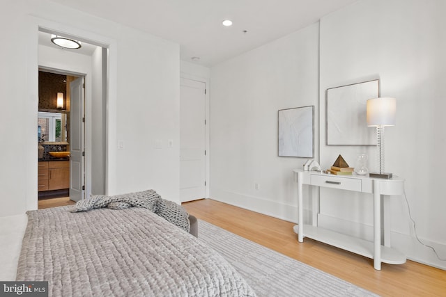 bedroom with recessed lighting, baseboards, and wood finished floors