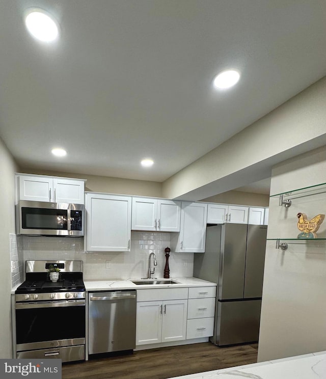 511 N Armistead St Unit T2, Alexandria, VA 22312 - kitchen with dark wood-style flooring, light countertops, white cabinets, a sink, and stainless steel appliances