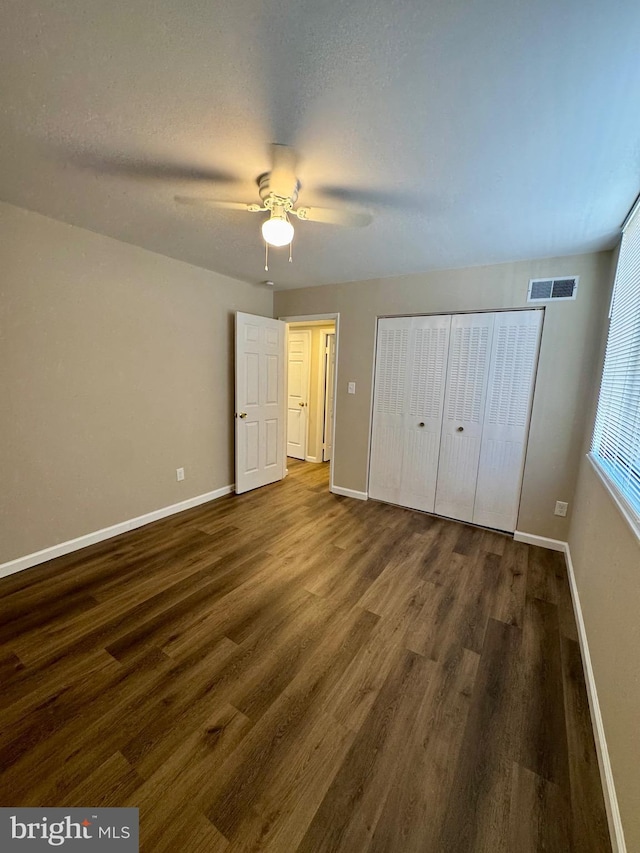 511 N Armistead St Unit T2, Alexandria, VA 22312 - unfurnished bedroom featuring visible vents, baseboards, dark wood-type flooring, and a closet