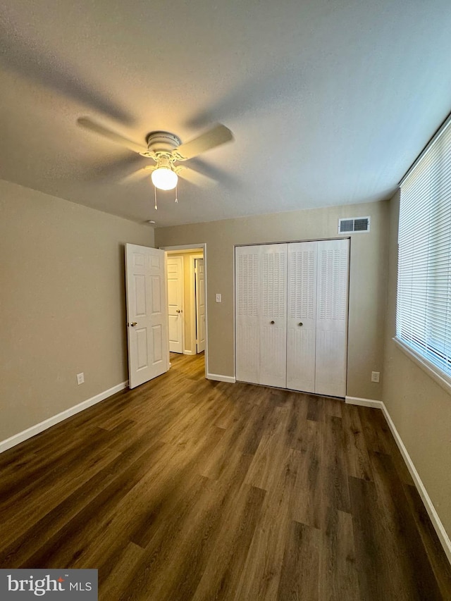 511 N Armistead St Unit T2, Alexandria, VA 22312 - unfurnished bedroom with visible vents, a closet, wood finished floors, baseboards, and ceiling fan