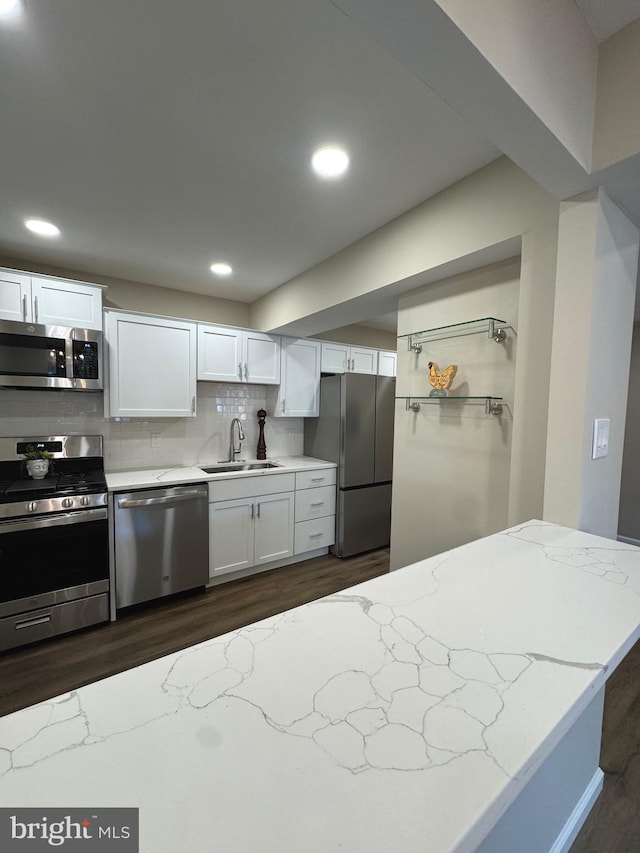 511 N Armistead St Unit T2, Alexandria, VA 22312 - kitchen with dark wood-style floors, white cabinets, light stone counters, a sink, and appliances with stainless steel finishes