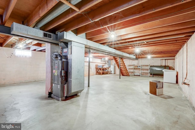 basement with heating unit, heating fuel, and visible vents