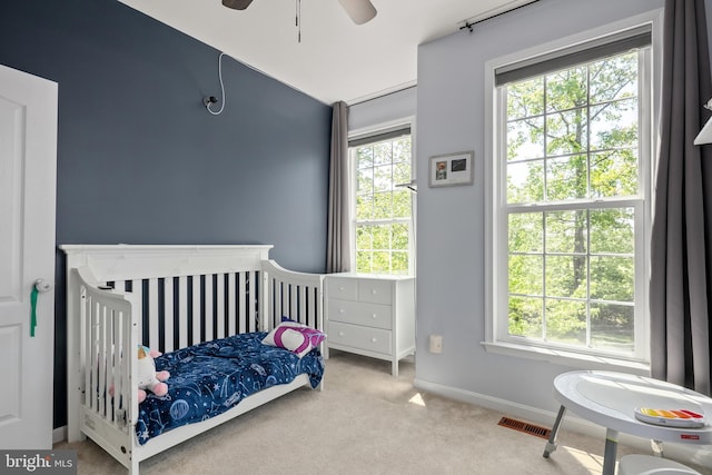 carpeted bedroom featuring baseboards, ceiling fan, lofted ceiling, and visible vents