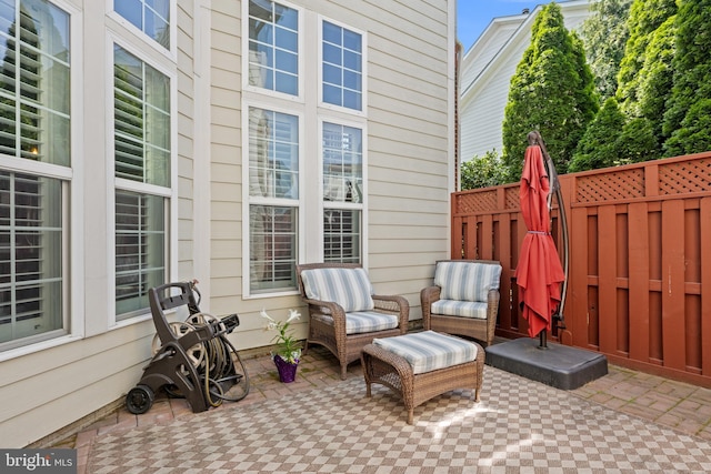 view of patio featuring fence and an outdoor hangout area