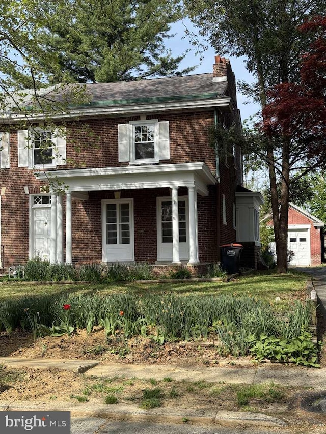 16 E Parkway Ave, Chester, PA 19013 - view of front facade with brick siding, covered porch, and a chimney
