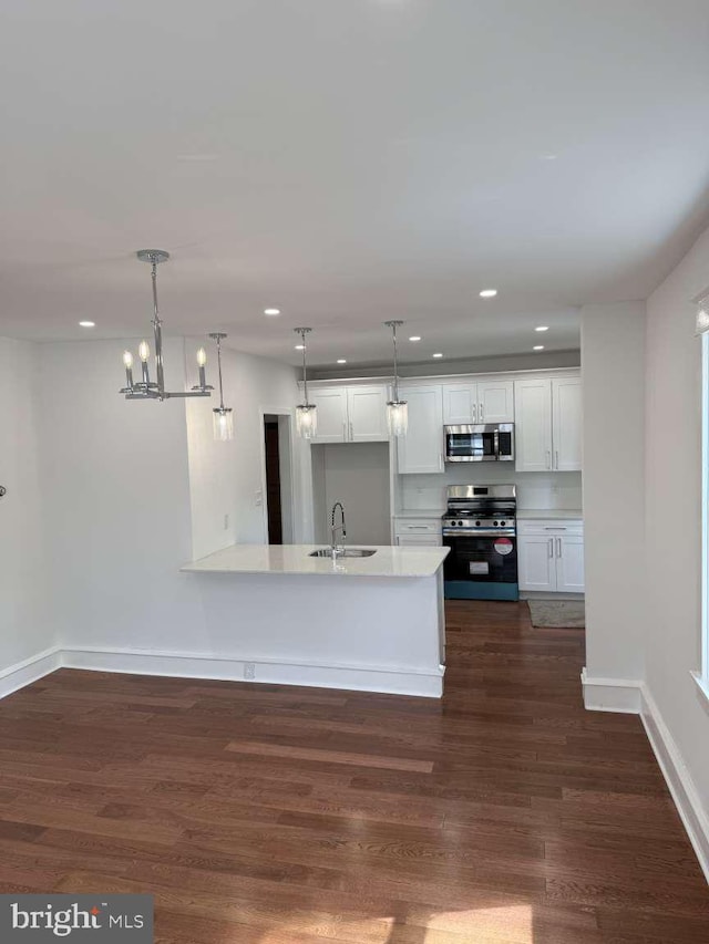 16 E Parkway Ave, Chester, PA 19013 - kitchen featuring dark wood-style flooring, recessed lighting, white cabinetry, a sink, and appliances with stainless steel finishes