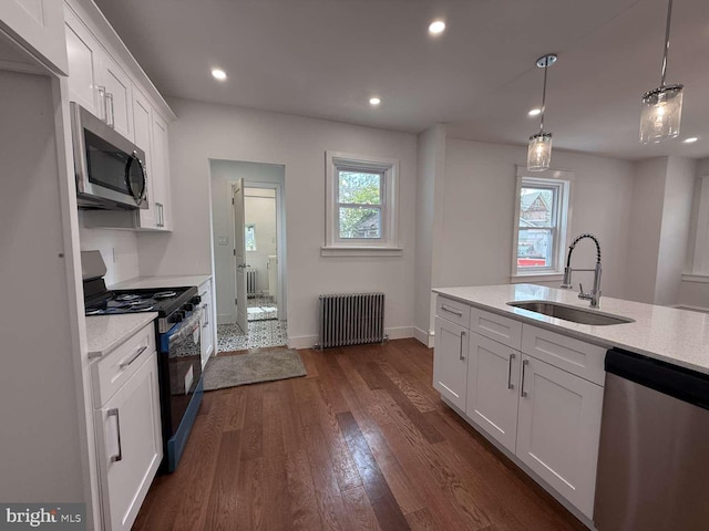 16 E Parkway Ave, Chester, PA 19013 - kitchen with dark wood-style flooring, a healthy amount of sunlight, radiator heating unit, a sink, and stainless steel appliances
