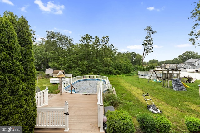 821 Green Ave, Mount Ephraim, NJ 08059 - view of pool with a lawn, a playground, and a wooden deck