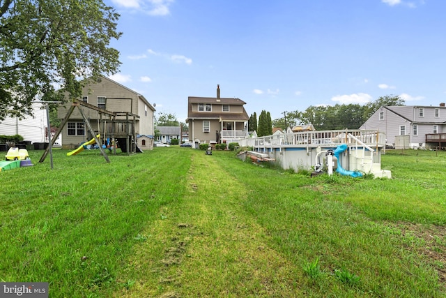 821 Green Ave, Mount Ephraim, NJ 08059 - view of grassy yard with an outdoor pool and a playground
