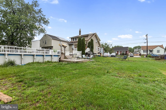 821 Green Ave, Mount Ephraim, NJ 08059 - rear view of house with a deck, an outdoor pool, a yard, and a residential view
