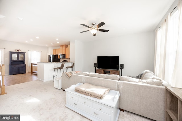living area featuring recessed lighting, ceiling fan, and light colored carpet
