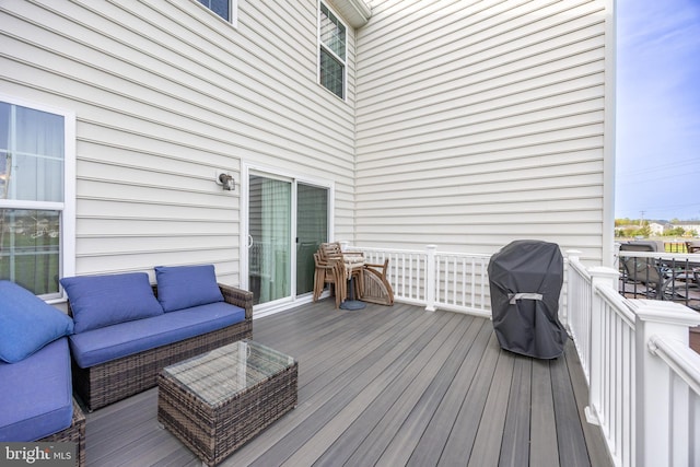 deck with an outdoor hangout area and area for grilling