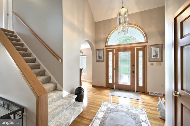6 Pond Ridge Ln, Hanover, PA 17331 - foyer entrance with arched walkways, stairway, a chandelier, light wood finished floors, and high vaulted ceiling