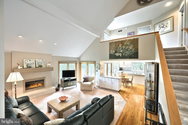 6 Pond Ridge Ln, Hanover, PA 17331 - living room with high vaulted ceiling, light wood-type flooring, stairs, a brick fireplace, and recessed lighting