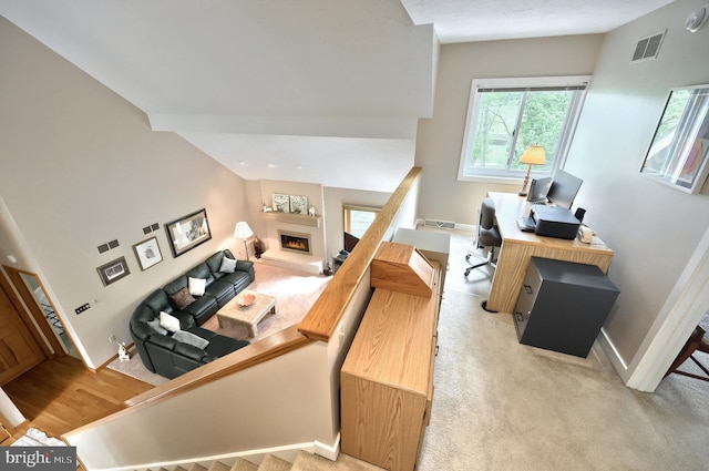 6 Pond Ridge Ln, Hanover, PA 17331 - home office with a warm lit fireplace, baseboards, and light colored carpet