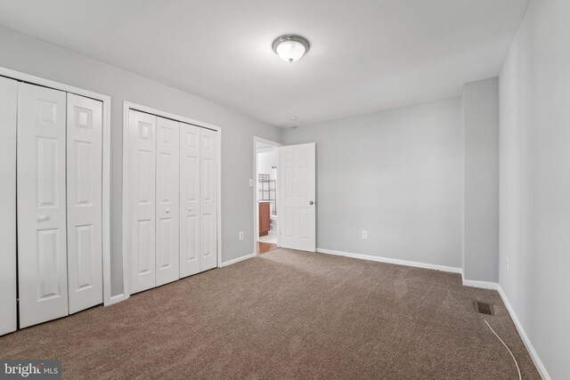 7113 Carriage Hill Dr, Laurel, MD 20707 - unfurnished bedroom with carpet, visible vents, multiple closets, and baseboards