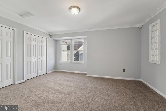 7113 Carriage Hill Dr, Laurel, MD 20707 - unfurnished bedroom featuring two closets, baseboards, ornamental molding, and carpet flooring