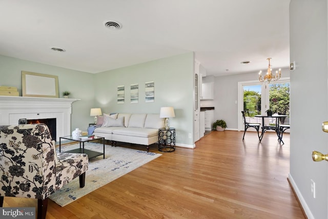 26105 Cornor Dr, Damascus, MD 20872 - living area with light wood-type flooring, a chandelier, and baseboards