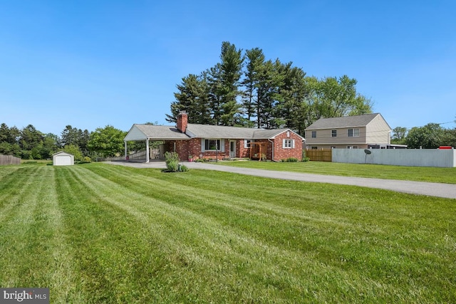26105 Cornor Dr, Damascus, MD 20872 - view of front of house featuring a chimney, a storage unit, an outbuilding, a porch, and driveway