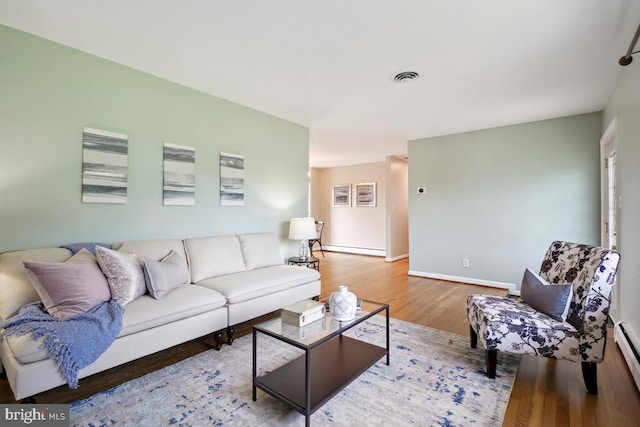 26105 Cornor Dr, Damascus, MD 20872 - living area with wood finished floors, baseboard heating, and baseboards