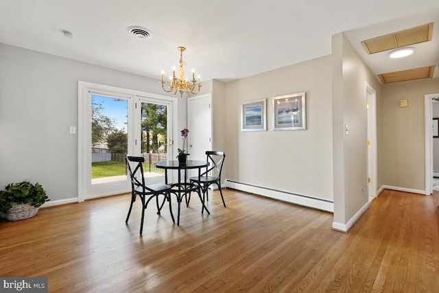 26105 Cornor Dr, Damascus, MD 20872 - dining area with a baseboard radiator, light wood-style flooring, baseboards, and a chandelier