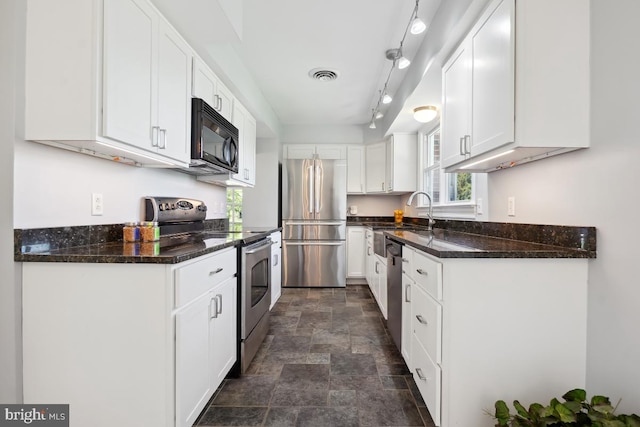 26105 Cornor Dr, Damascus, MD 20872 - kitchen with appliances with stainless steel finishes, stone finish floors, white cabinetry, and dark stone countertops