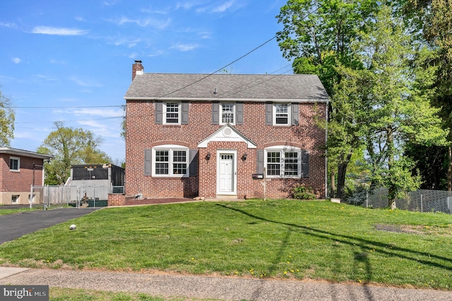 666 Dutton Cir, Springfield, PA 19064 - colonial inspired home featuring fence, a chimney, and brick siding