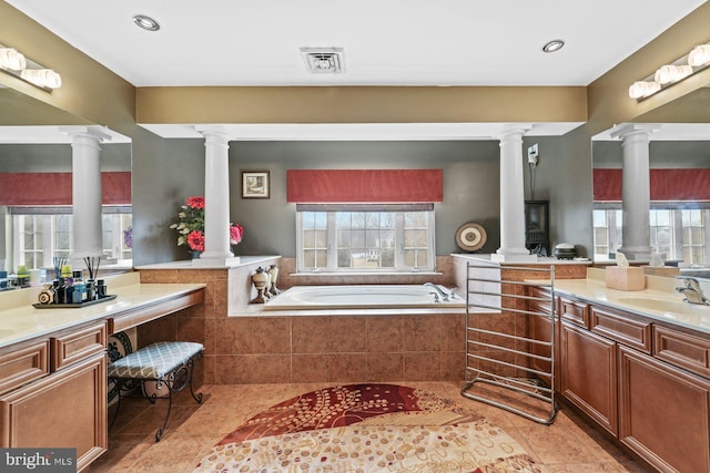 full bathroom with decorative columns, plenty of natural light, and visible vents