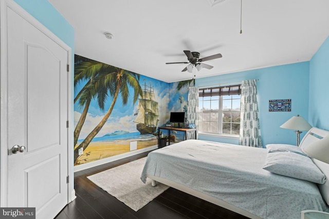 bedroom featuring ceiling fan, dark wood-style floors, wallpapered walls, and attic access