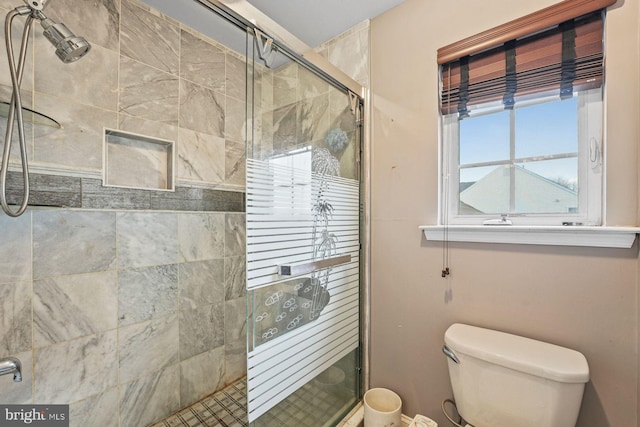 full bath with toilet and a shower stall