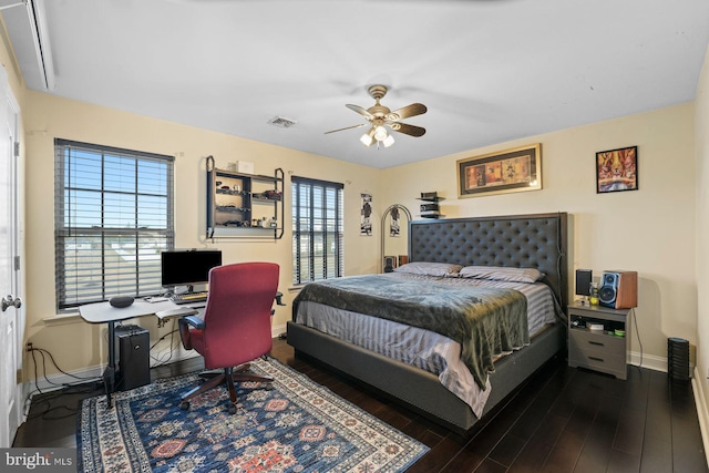 bedroom with baseboards, a ceiling fan, wood finished floors, and visible vents