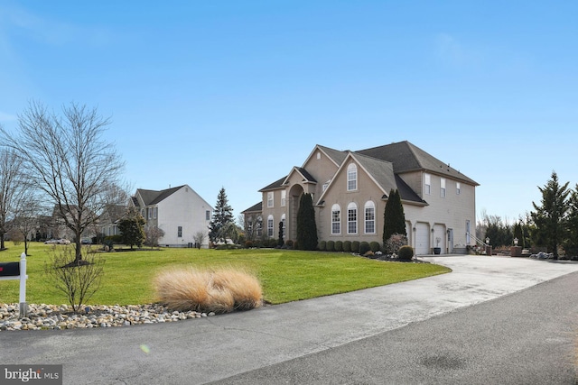 exterior space with a garage, driveway, and a front yard