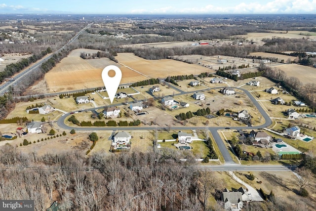 birds eye view of property with a rural view