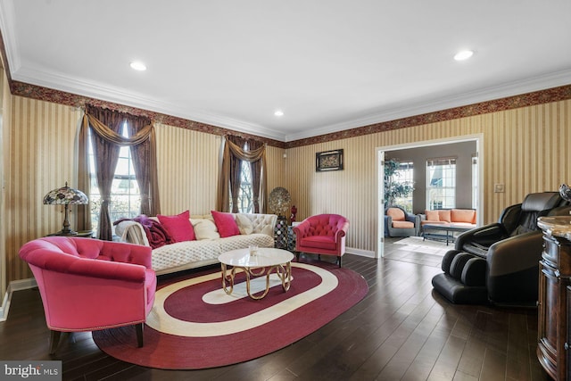 living area featuring crown molding, wallpapered walls, baseboards, and hardwood / wood-style floors
