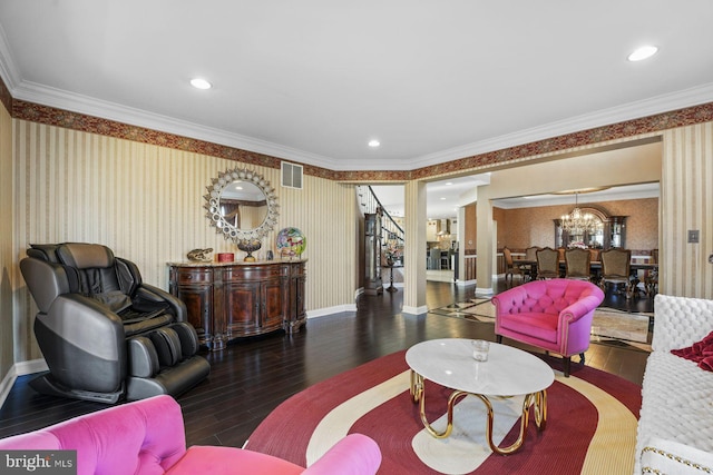 living area with crown molding, hardwood / wood-style flooring, wallpapered walls, and visible vents