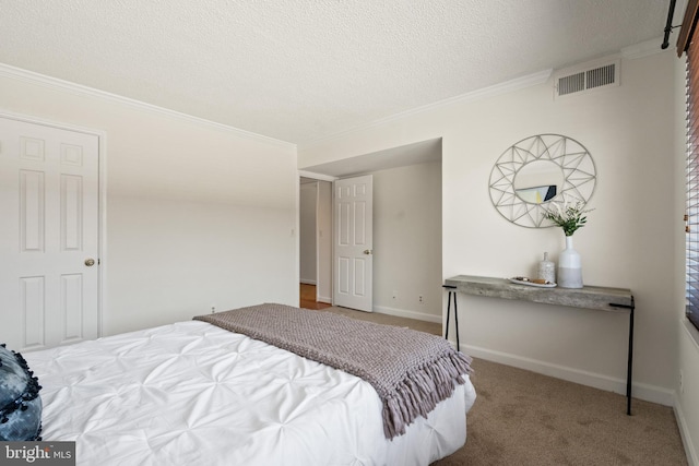 1077 30th St NW Unit 612, Washington, DC 20007 - bedroom with ornamental molding, a textured ceiling, carpet flooring, and baseboards