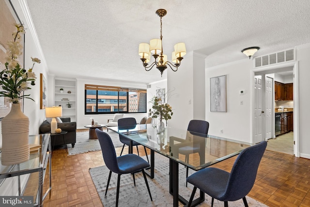 1077 30th St NW Unit 612, Washington, DC 20007 - dining room with ornamental molding, a textured ceiling, a chandelier, built in features, and baseboards