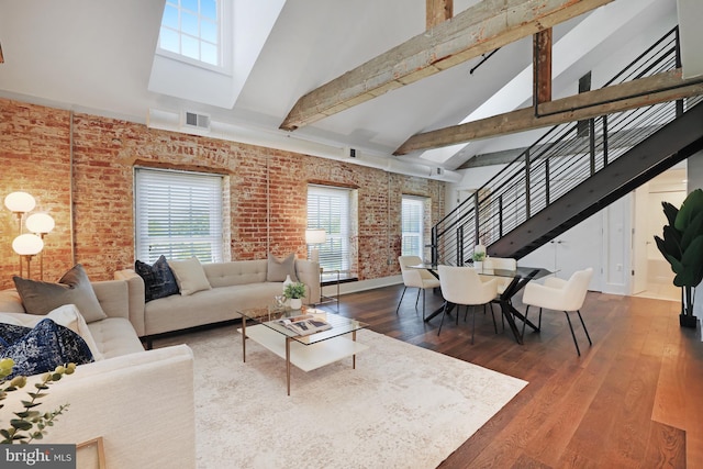 515 N Washington St Unit 404, Alexandria, VA 22314 - living area featuring brick wall, visible vents, a wealth of natural light, and high vaulted ceiling