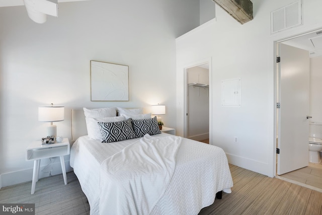 515 N Washington St Unit 404, Alexandria, VA 22314 - bedroom featuring a walk in closet, baseboards, wood finished floors, visible vents, and a closet