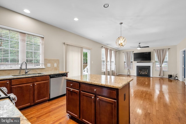 17202 Madrillon Way, Accokeek, MD 20607 - kitchen featuring appliances with stainless steel finishes, a ceiling fan, a glass covered fireplace, light wood-type flooring, and pendant lighting