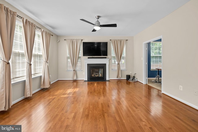 17202 Madrillon Way, Accokeek, MD 20607 - unfurnished living room with light wood-style flooring, a ceiling fan, and a fireplace with flush hearth